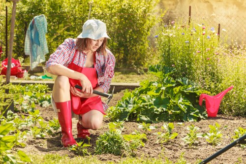 Workers managing waste clearance safely during outdoor landscaping work