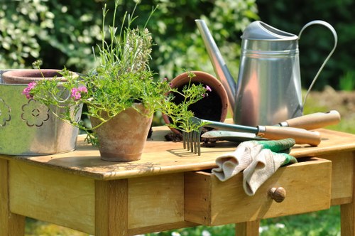 Garden maintenance tools and neatly trimmed hedges in a Heston outdoor space